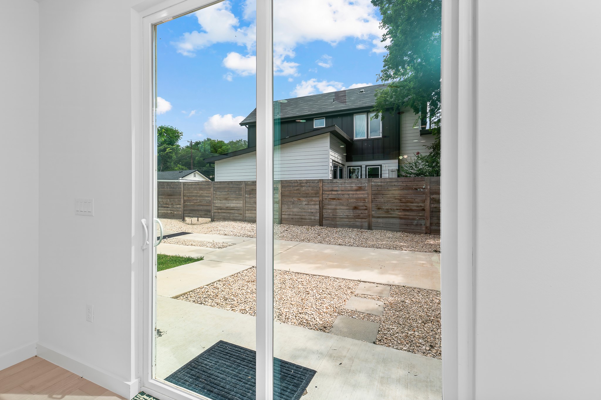 5305 Ledesma Road, Unit 4 Austin, TX 78721 - Photo 12 of 40 Sliding glass doors offer a clear view of the private outdoor space, ready for personalization.