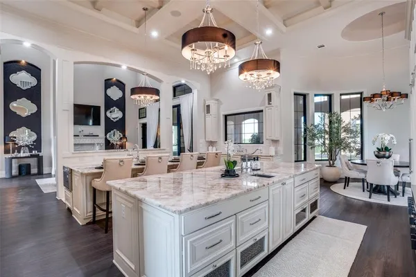 a large spacious bathroom with a granite countertop sink a large mirror and vanity