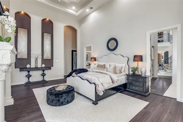 a spacious bedroom with two beds and wooden floor