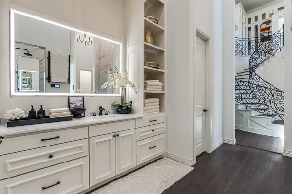 a spacious bathroom with double vanity and a mirror
