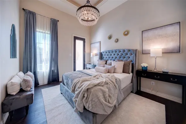 a bedroom with a bed and a large mirror