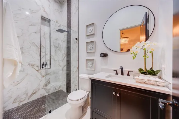 a bathroom with a sink a toilet and a mirror