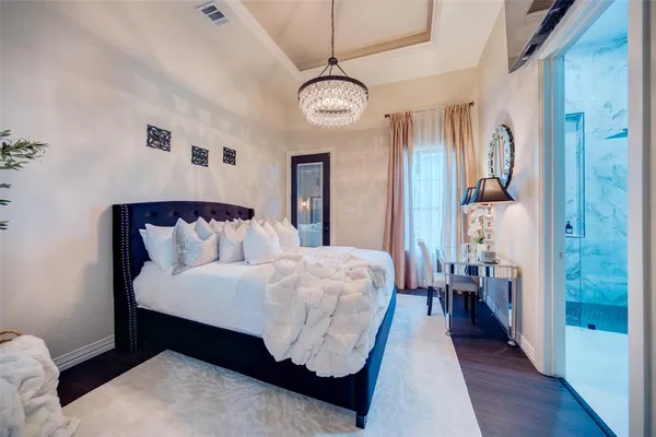 a bed room with a bed and a chandelier