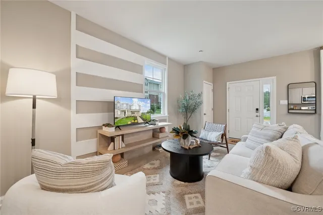 a living room with furniture and a potted plant