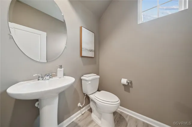 a white toilet sitting next to a bathroom sink
