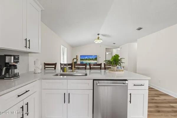 a kitchen with kitchen island granite countertop counter top space and wooden floor