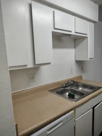a kitchen with kitchen island granite countertop wooden cabinets and a stove