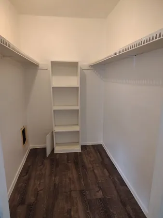 a view of a room with wooden floor
