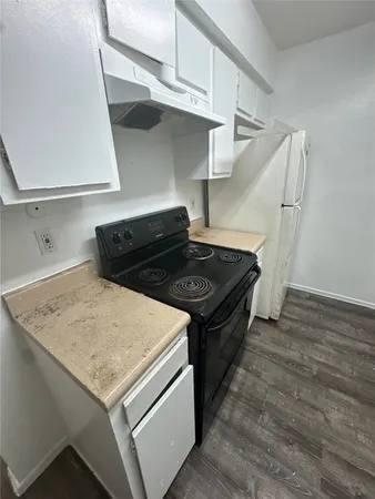a kitchen with a stove and a refrigerator