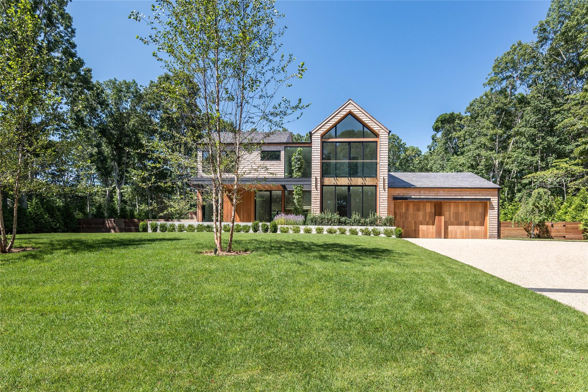 47 Pheasant Road Sag Harbor, NY 11963 - Photo 1 of 1 View of front of property with a front lawn, an attached garage, and driveway