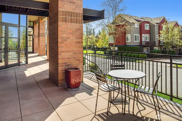 a view of a chairs and table in the balcony
