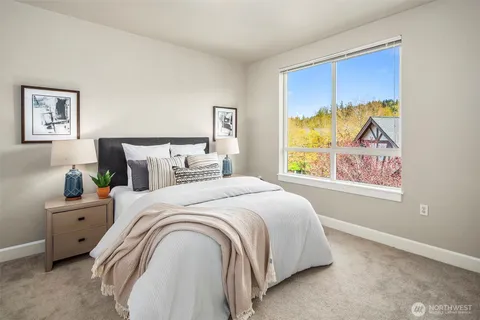 a bedroom with a bed and a painting on the wall