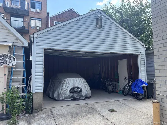 a view of a house with a balcony and a car parked in front of house