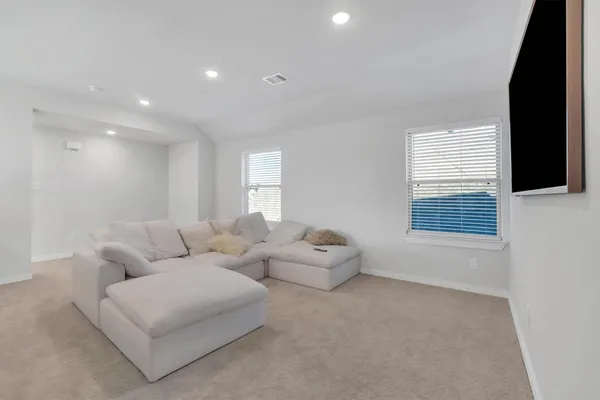 a bed sitting in a bedroom next to a window