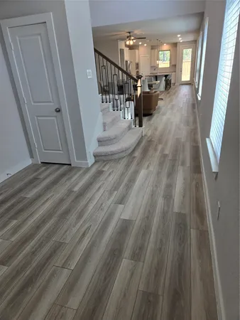 a view of a hallway view with wooden floor and staircase