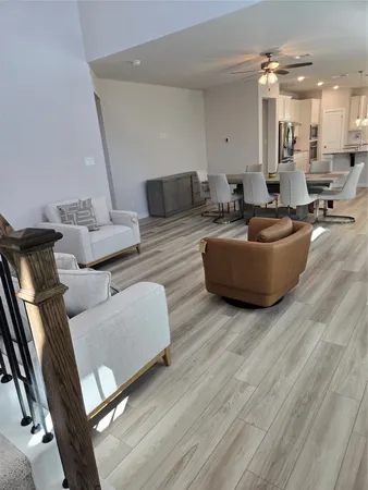 a living room with furniture and a hard wood floor