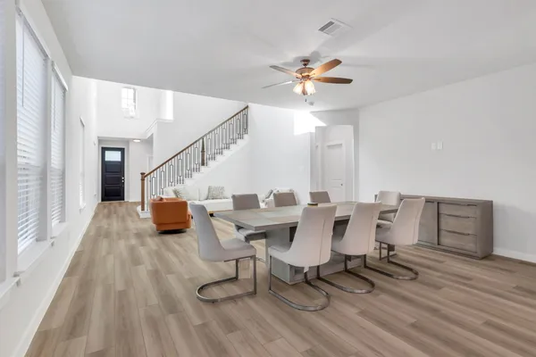 a kitchen with stainless steel appliances granite countertop a stove a refrigerator a kitchen island a sink and a refrigerator