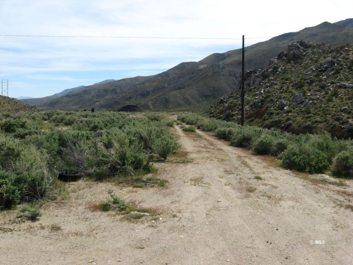 350 Little Lake Road Inyokern, CA 93527 - Photo 11 of 26 a view of a dry yard with mountains in the background