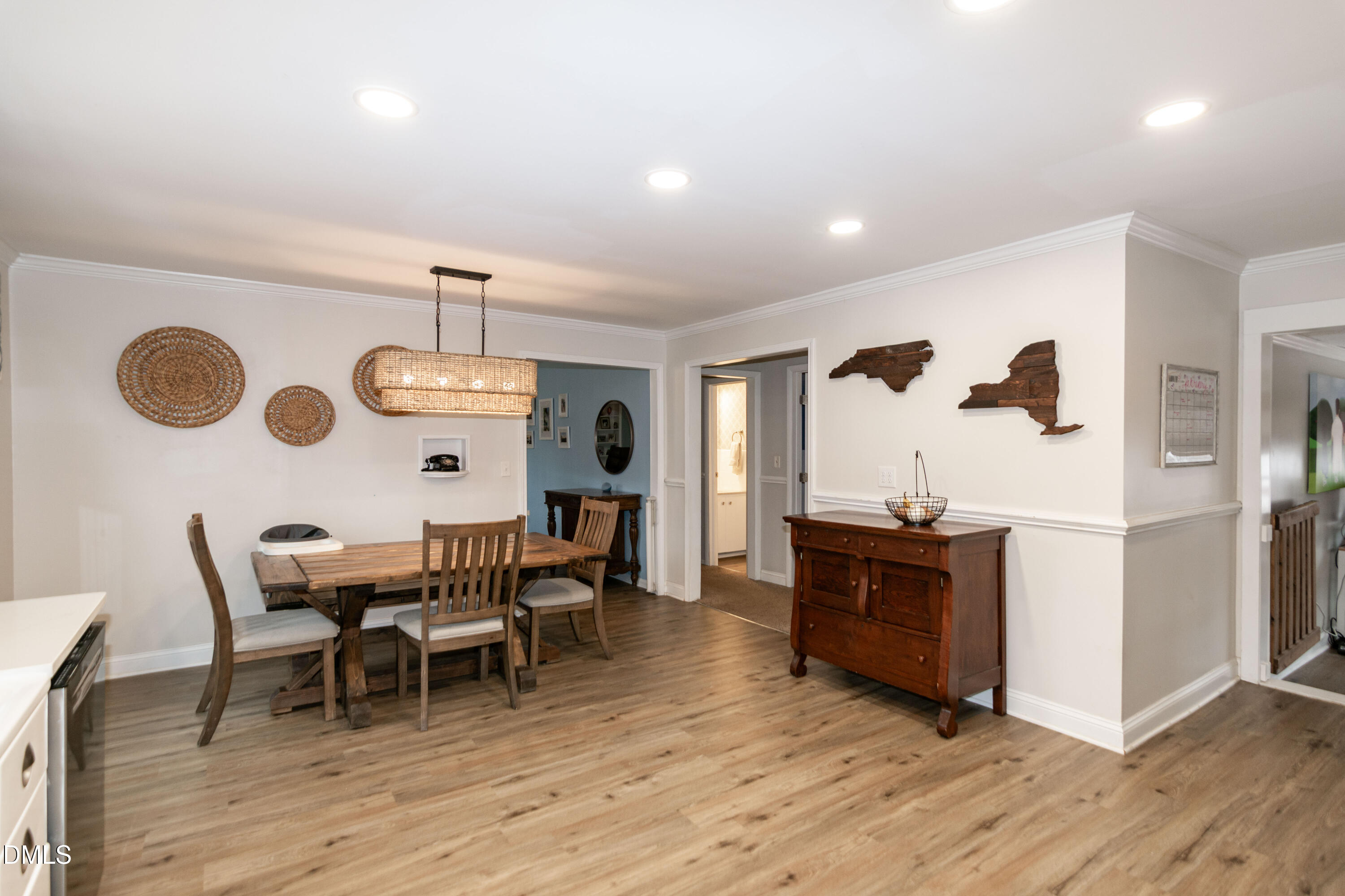 1009 Old Ferrell Road Knightdale, NC 27545 - Photo 10 of 42 a dining room with wooden floor furniture and a chandelier