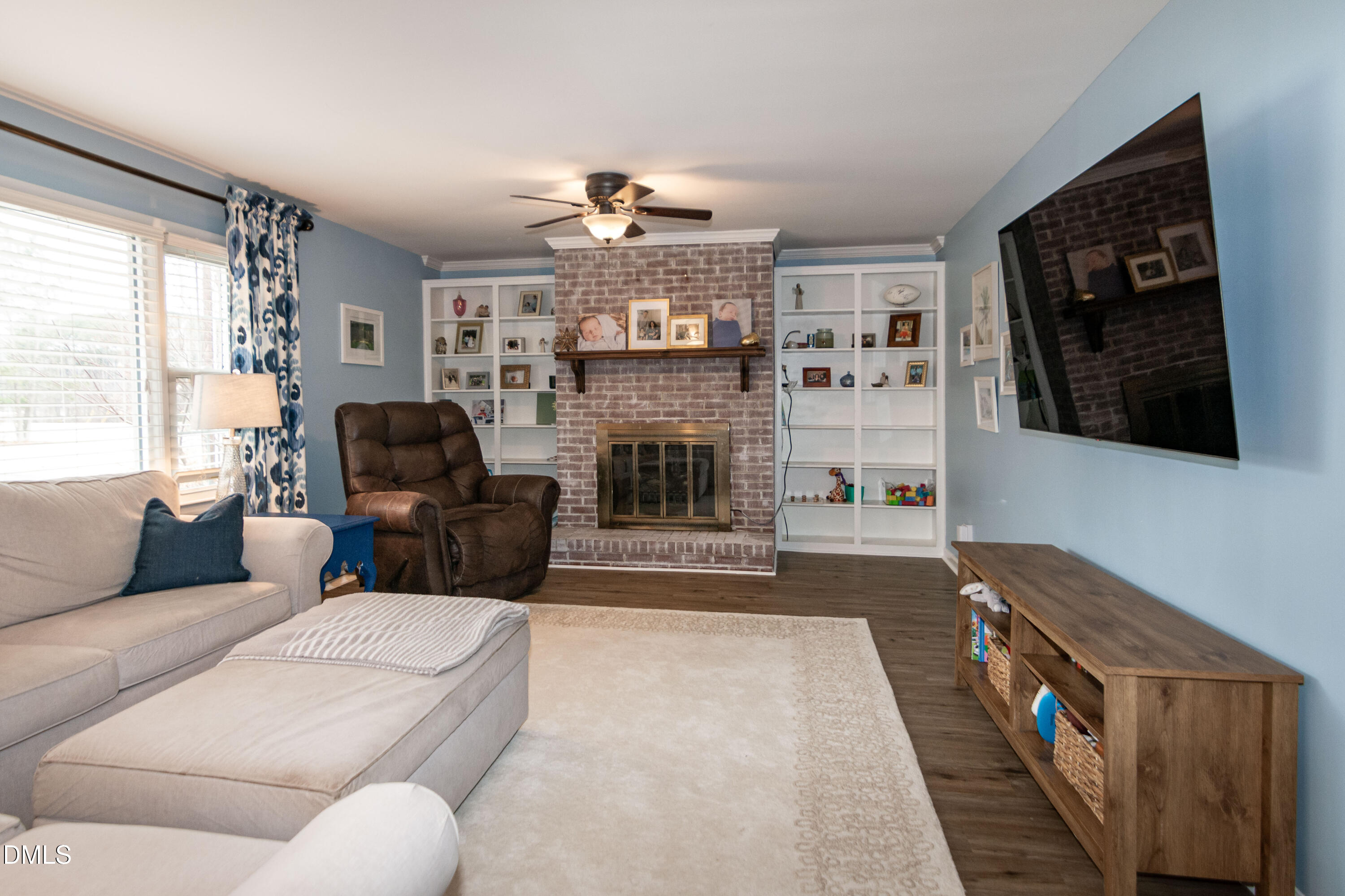 1009 Old Ferrell Road Knightdale, NC 27545 - Photo 12 of 42 a living room with furniture a fireplace and a flat screen tv