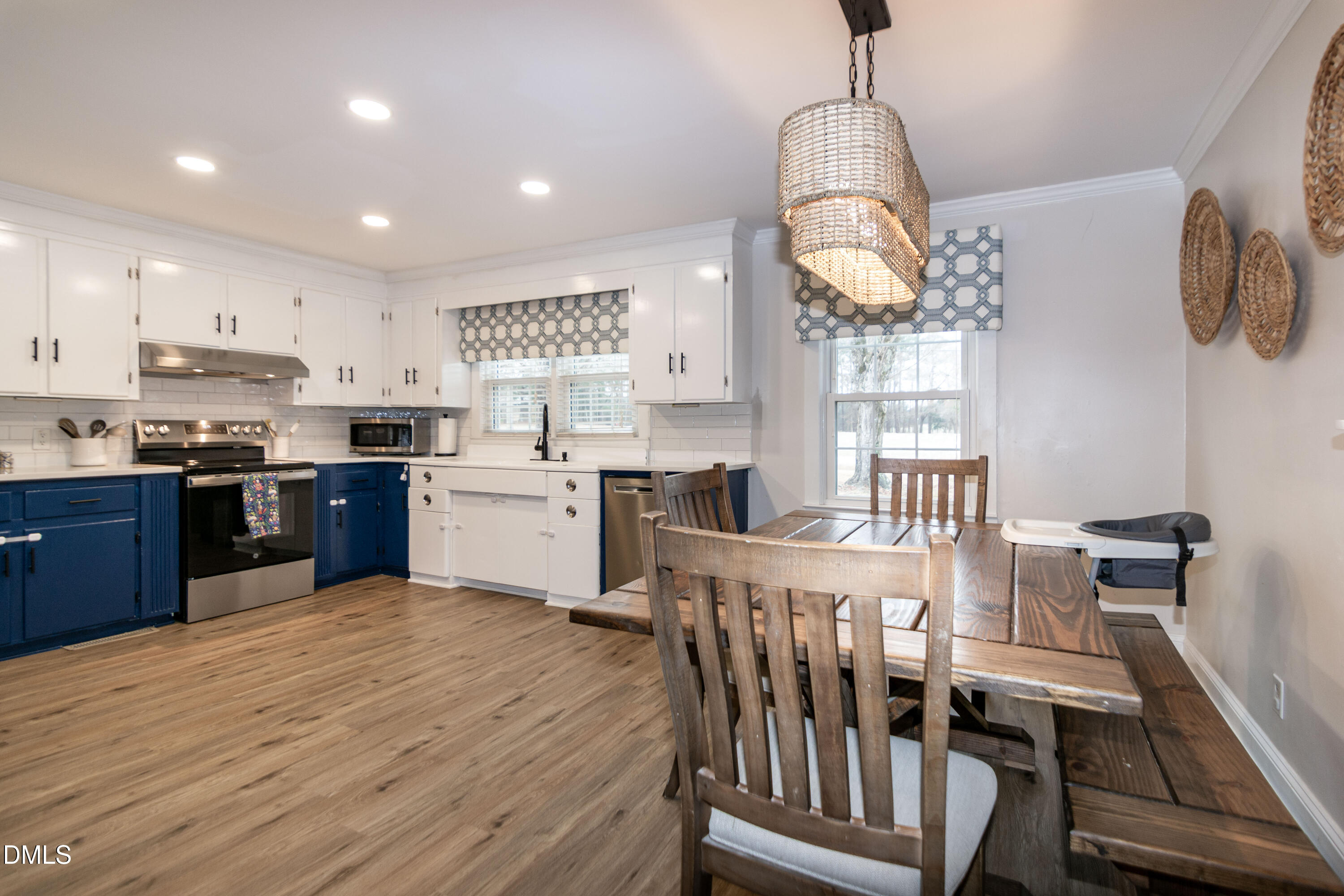 1009 Old Ferrell Road Knightdale, NC 27545 - Photo 5 of 42 a kitchen with stainless steel appliances granite countertop a stove top oven a sink dishwasher and white cabinets with wooden floor