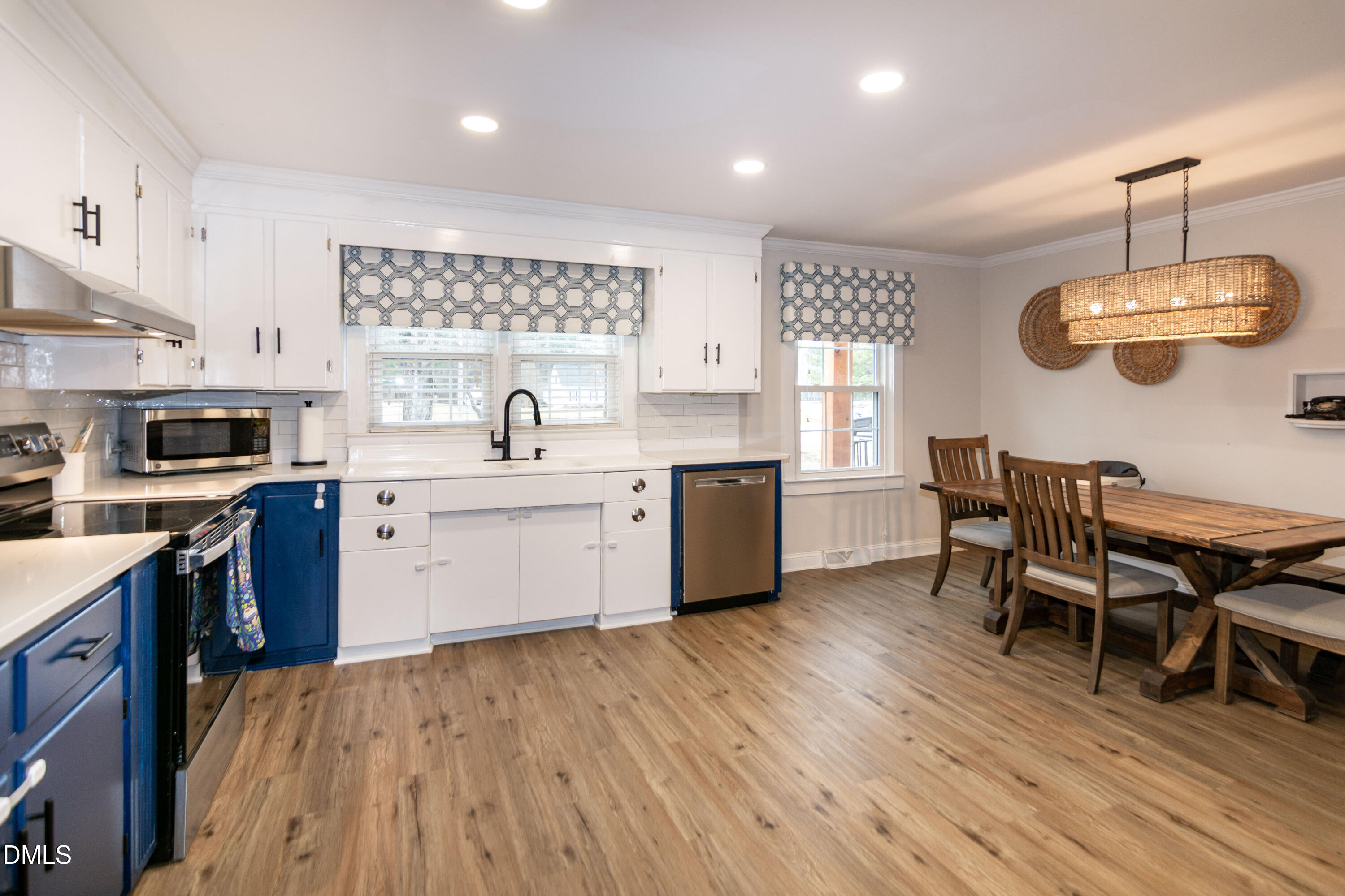 1009 Old Ferrell Road Knightdale, NC 27545 - Photo 7 of 42 a kitchen with a table chairs sink and cabinets