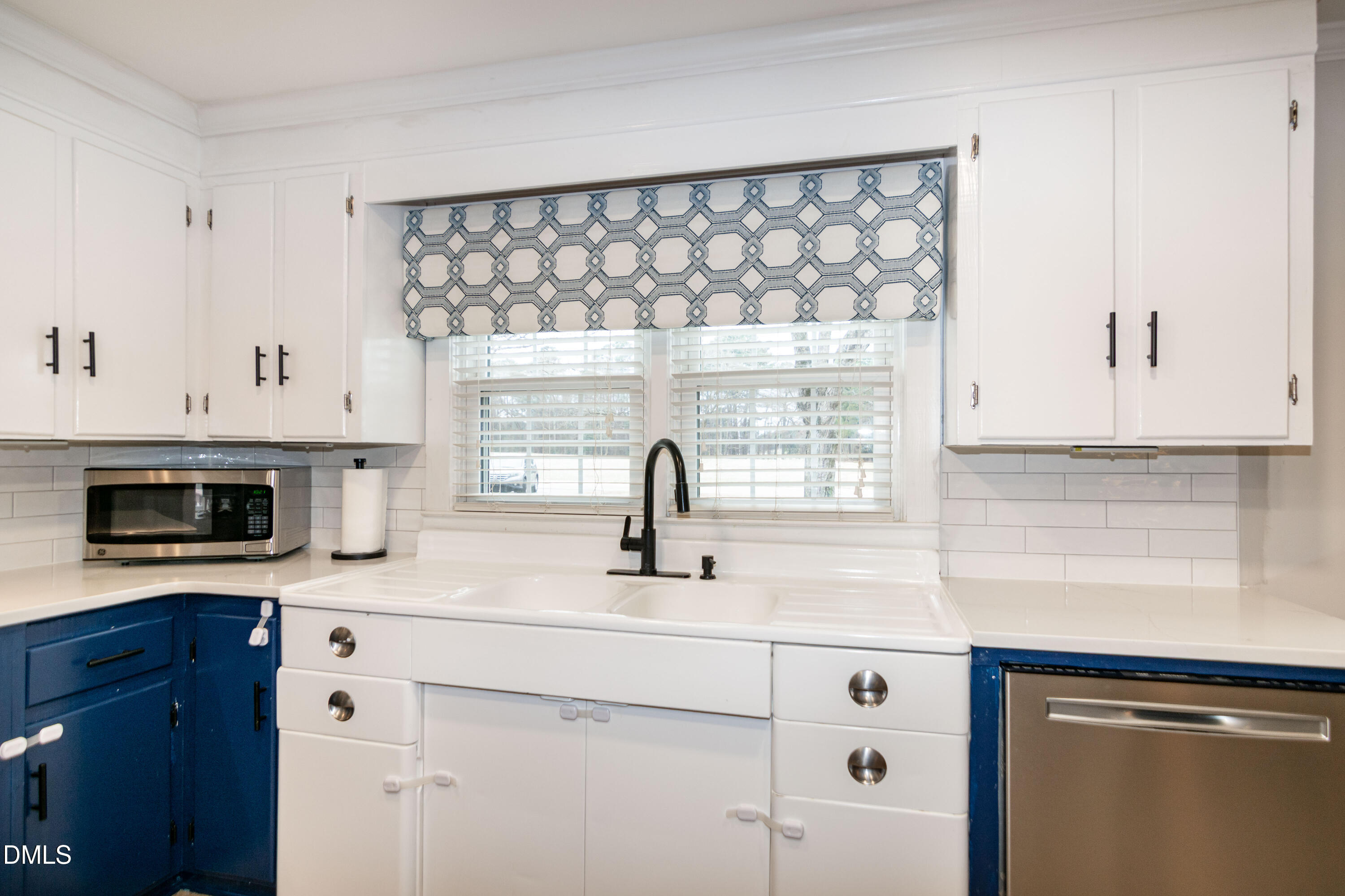 1009 Old Ferrell Road Knightdale, NC 27545 - Photo 9 of 42 a kitchen with white cabinets and a sink