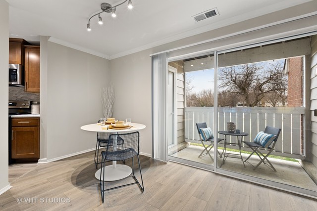 1630 Buttonwood Circle, Unit 3215 Schaumburg, IL 60173 - Photo 9 of 29 a view of a dining room with furniture window and outside view