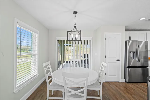 a view of a room with wooden floor windows and a chandelier