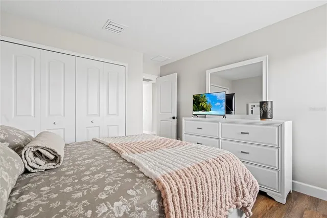 a bedroom with a large bed and a dresser