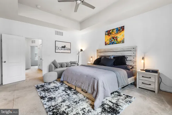 a bedroom with a bed and a couch