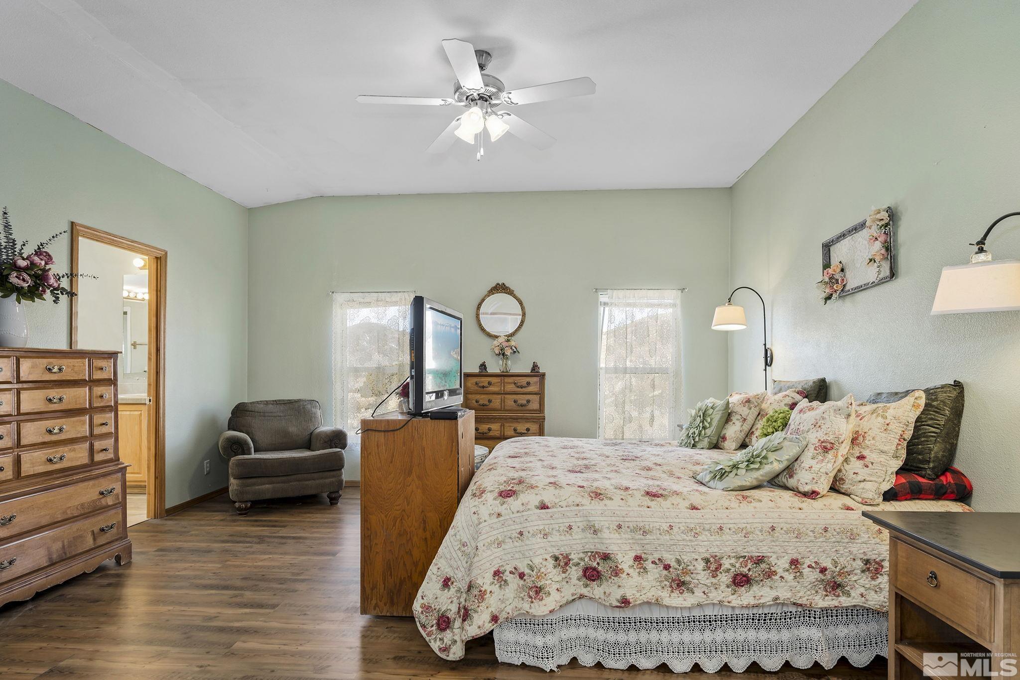 3880 Tree Farm Court Reno, NV 89510 - Photo 8 of 36 a bedroom with a bed and wooden floor