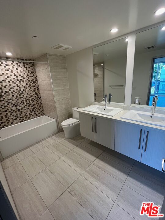 1301 South Westgate Avenue, Unit 302 Los Angeles, CA 90025 - Photo 6 of 12 a bathroom with a sink toilet and shower