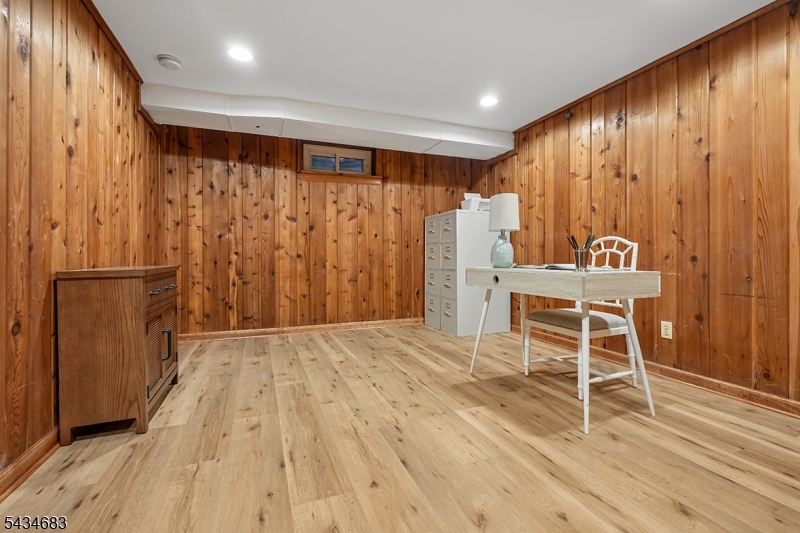 106 Division Avenue Summit, NJ 07901 - Photo 29 of 38 a room with wooden floor and furniture