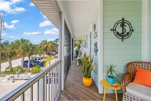 a view of a balcony with chairs