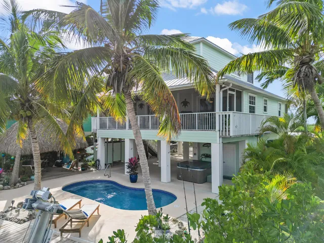 a wooden bench sitting in backside of a house