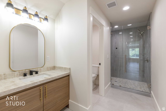 1188 South Old Trappers Loop Road Huntsville, UT 84317 - Photo 63 of 92 Modern bathroom featuring a wood-finish vanity with gold-tone hardware, a light-toned countertop, and a sleek rectangular undermount sink with a matte black faucet