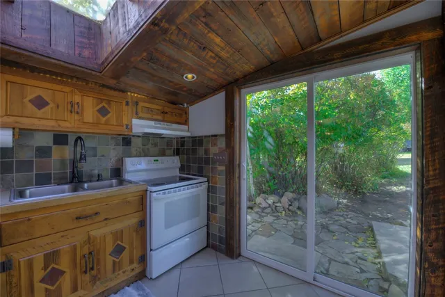 a kitchen with a refrigerator and a stove