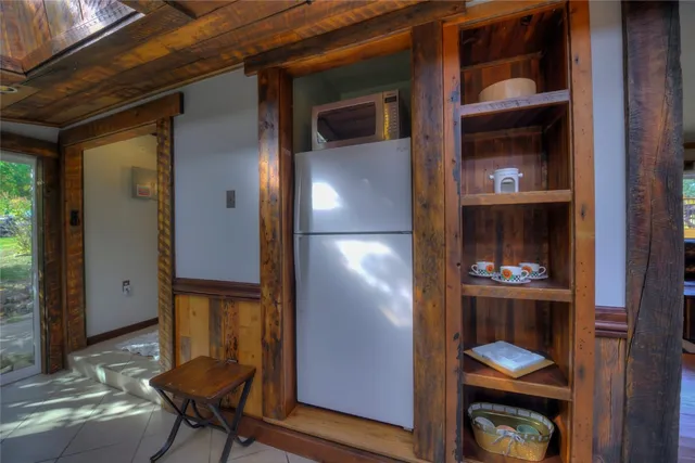 a bedroom with a bed and window with lamp