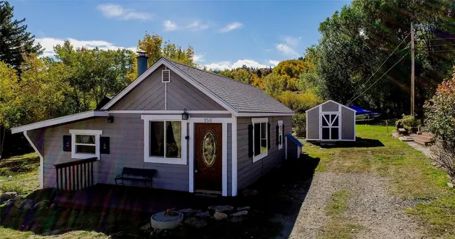 a front view of a house with a yard table and chairs