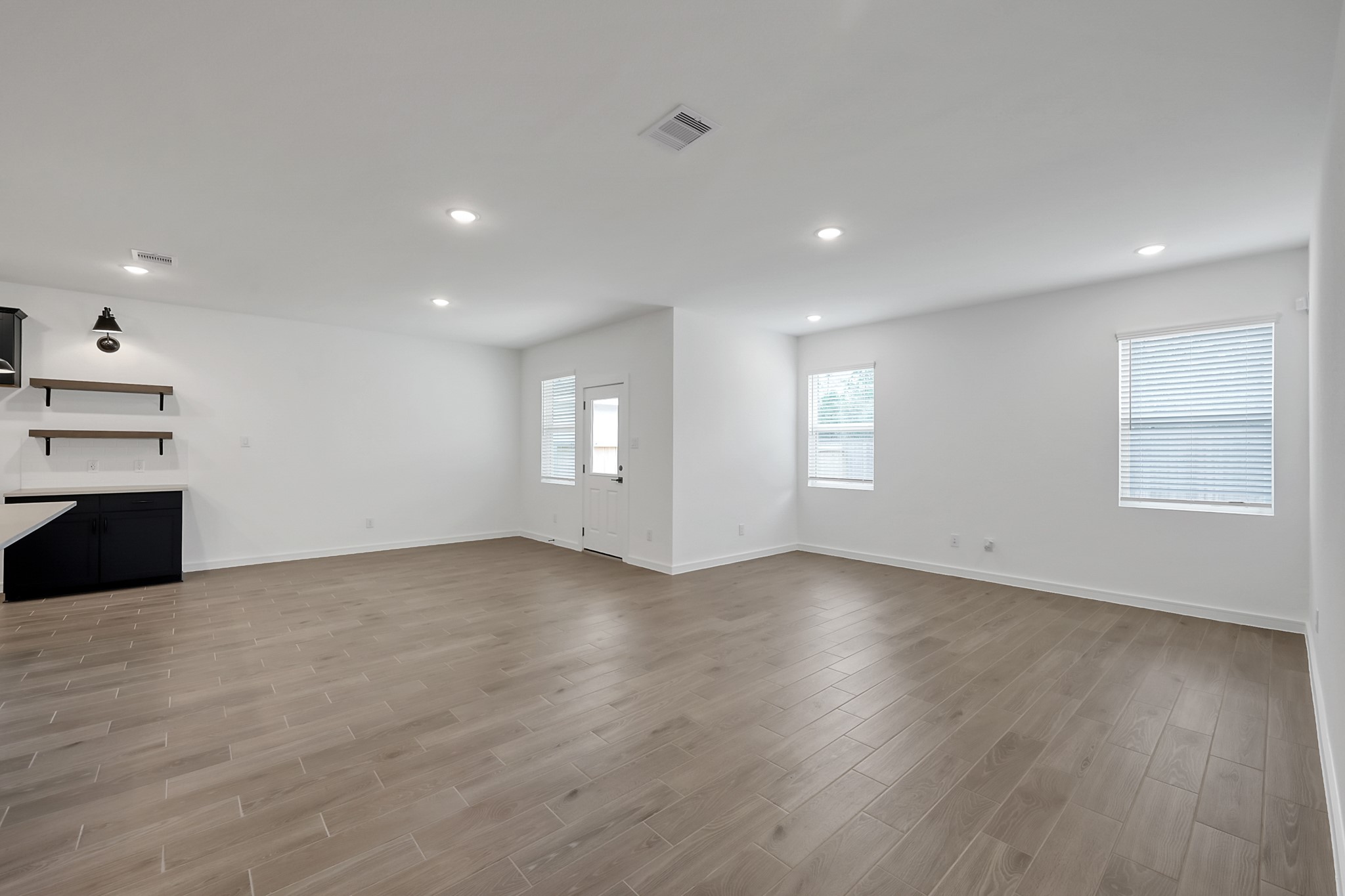 516 Monarch Trail Huntsville, TX 77340 - Photo 9 of 20 a view of an empty room with a window and wooden floor
