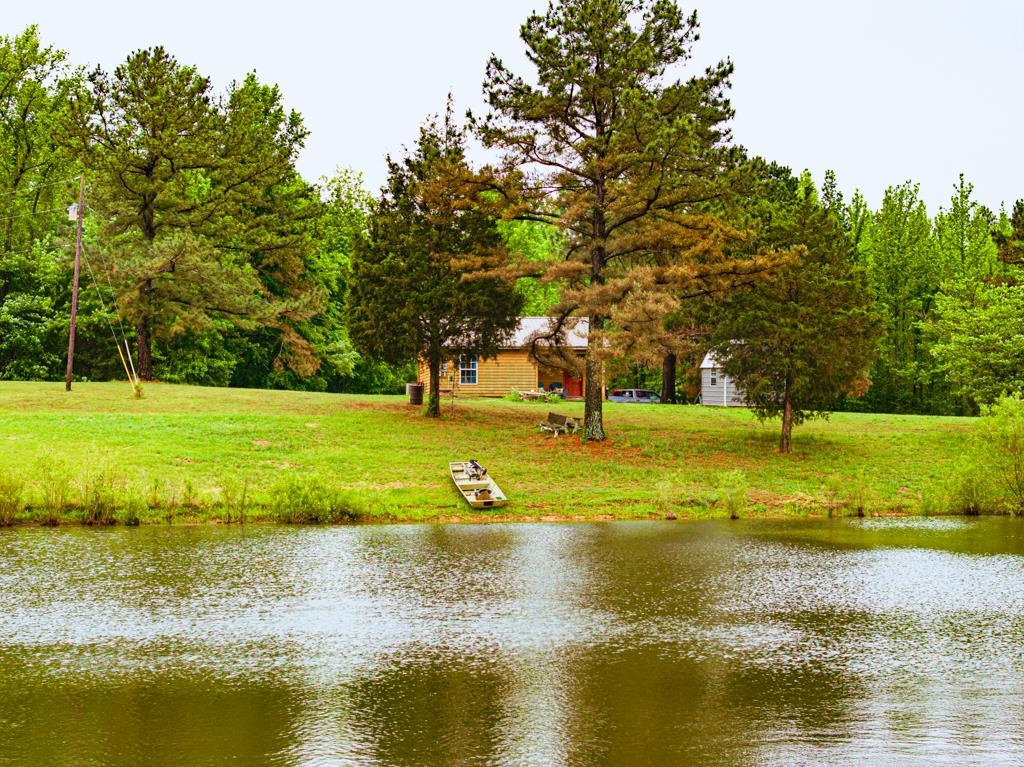 0 Poplar Grove Cemetery Road Henning, TN 38041 - Photo 2 of 40 Expansive waterfront property featuring a large pond and a green lawn