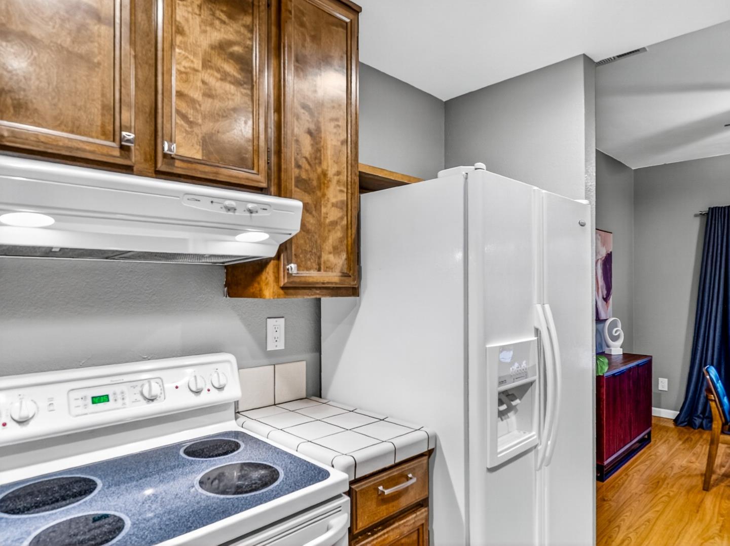 425 Kenbrook Circle San Jose, CA 95111 - Photo 11 of 46 a white refrigerator freezer sitting inside of a kitchen