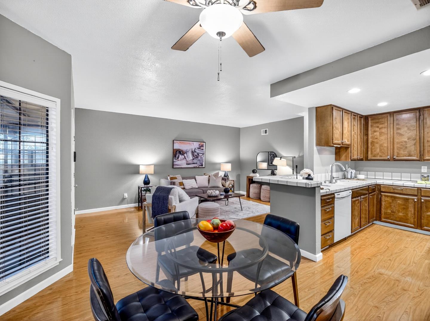 425 Kenbrook Circle San Jose, CA 95111 - Photo 15 of 46 a kitchen with stainless steel appliances granite countertop a stove a sink a dining table and chairs with wooden floor