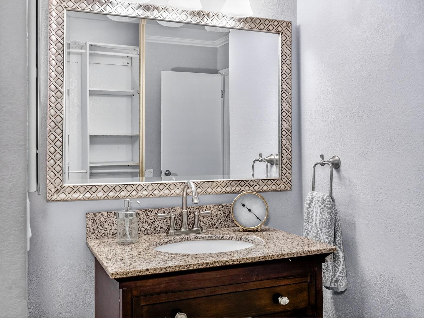 425 Kenbrook Circle San Jose, CA 95111 - Photo 26 of 46 a bathroom with a granite countertop sink and a mirror