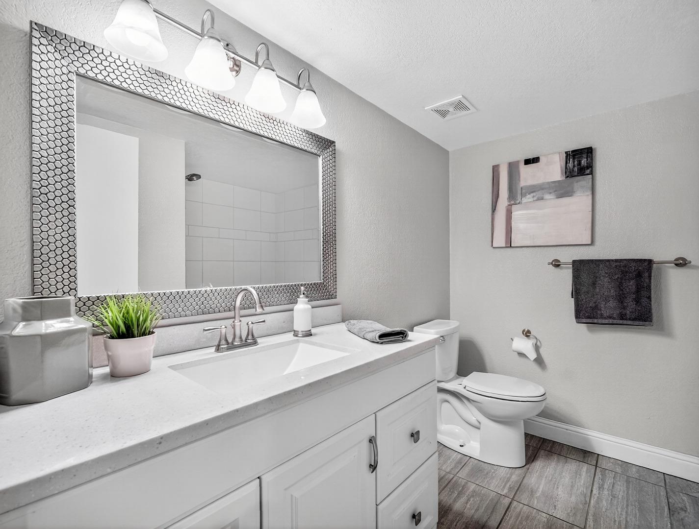 425 Kenbrook Circle San Jose, CA 95111 - Photo 35 of 46 a bathroom with a toilet a sink and mirror