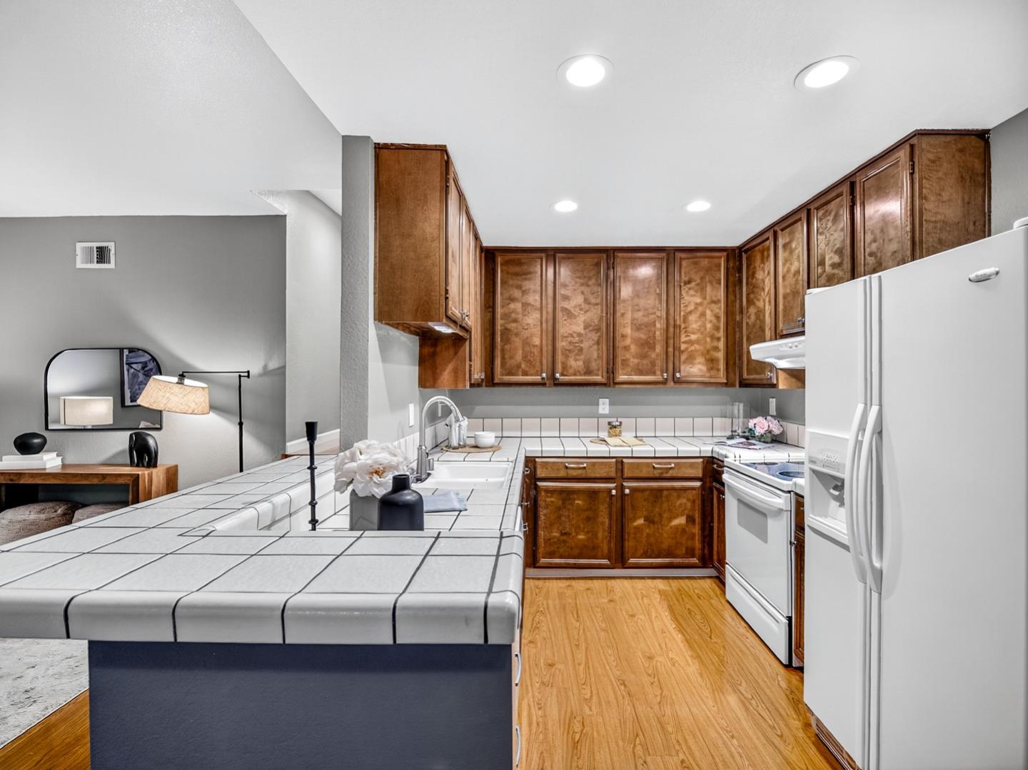 425 Kenbrook Circle San Jose, CA 95111 - Photo 5 of 46 a kitchen with kitchen island granite countertop a sink stove and refrigerator
