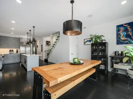 a living room with dining table and a table