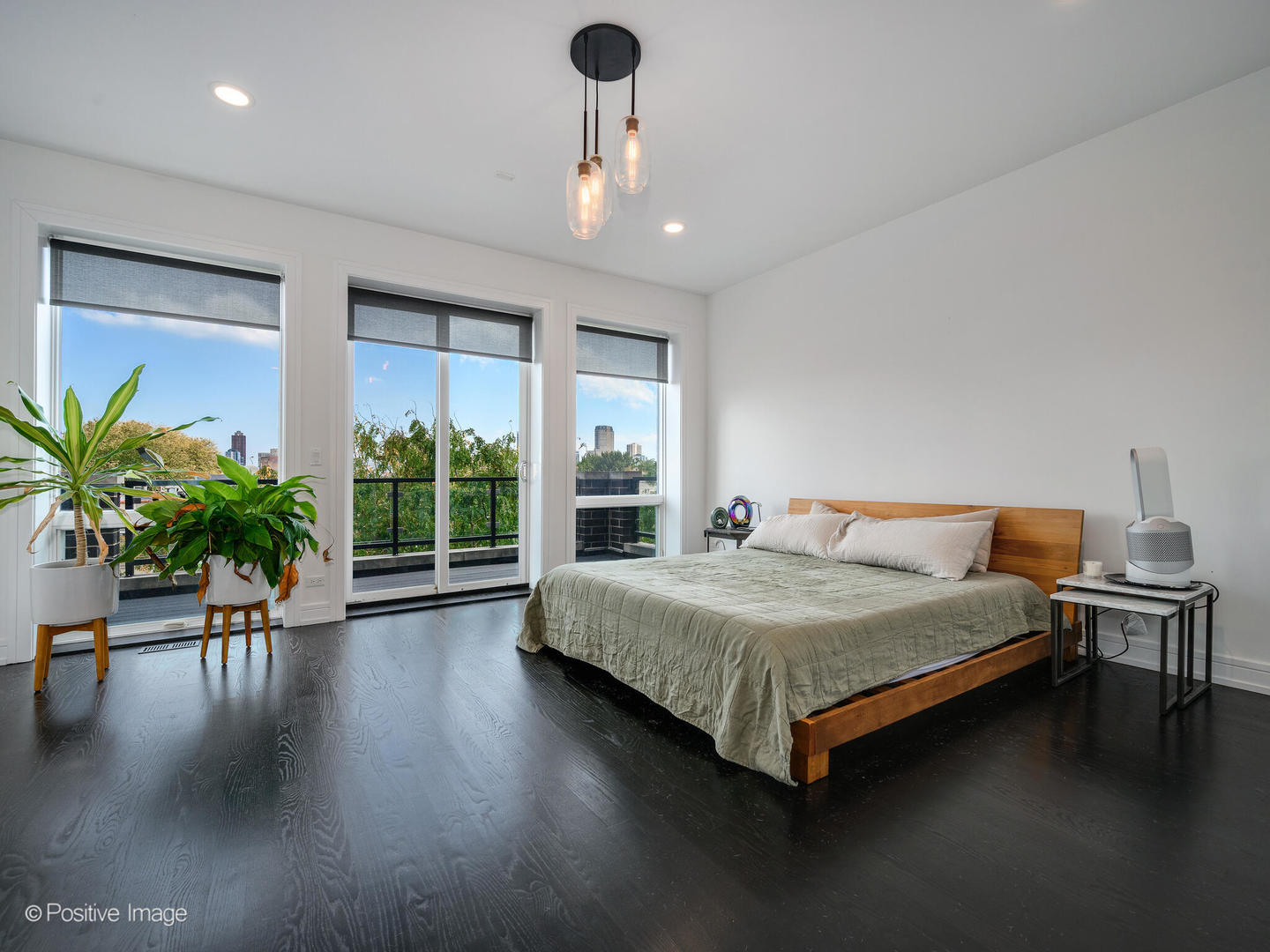 2922 North Sheffield Avenue, Unit 3 Chicago, IL 60657 - Photo 18 of 28 a bedroom with a large bed chandelier and a window