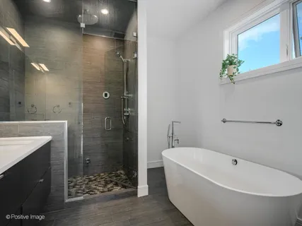 a bathroom with a bathtub and shower